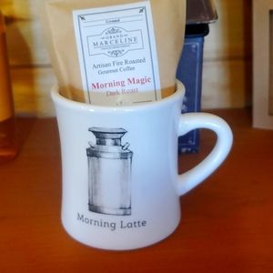 New ceramic coffee mug with package of flavored ground coffee